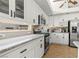 Well-lit kitchen featuring granite countertops, white cabinets, tile floors, and stainless steel appliances at 2080 Silver Breeze Ave, Las Vegas, NV 89183