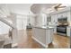 Bright kitchen featuring an island with seating, tile flooring, white cabinets, and stainless steel appliances at 2080 Silver Breeze Ave, Las Vegas, NV 89183