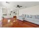 Spacious living room with hardwood floors, a gray sofa, and an open view to the kitchen and dining area at 2080 Silver Breeze Ave, Las Vegas, NV 89183