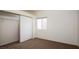 Cozy bedroom with neutral carpet, window, and closet with sliding doors at 2110 Los Feliz St # 1034, Las Vegas, NV 89156