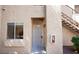 Tan exterior with security door, window, and fire extinguisher box at 2110 Los Feliz St # 1034, Las Vegas, NV 89156