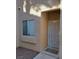 Exterior front entrance with secure door and window on tan-colored building at 2110 Los Feliz St # 1034, Las Vegas, NV 89156
