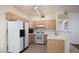 Kitchen featuring light-colored cabinets, tile flooring, and white appliances at 2110 Los Feliz St # 1034, Las Vegas, NV 89156