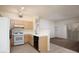 Bright kitchen features stainless steel appliances and adjacent living area with sliding glass doors at 2110 Los Feliz St # 1034, Las Vegas, NV 89156