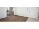Neutral living room with plush carpeting, sliding glass door, and entry door at 2110 Los Feliz St # 1034, Las Vegas, NV 89156