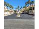 Street view lined with palm trees and residential buildings leading towards the mountains in the distance at 2110 Los Feliz St # 1034, Las Vegas, NV 89156