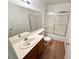 Bright bathroom with wood-look flooring, a tub/shower combo, and vanity with a large mirror at 2160 Highpointe Dr # 102, Laughlin, NV 89029