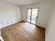Bedroom featuring sliding glass door, clean walls, and wood floors at 2160 Highpointe Dr # 102, Laughlin, NV 89029