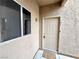 Condo front entrance featuring a beige door and a 