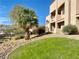 Well maintained exterior near rock landscaping and grassy areas with mature landscaping at 2160 Highpointe Dr # 102, Laughlin, NV 89029