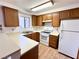 Kitchen with white appliances, wood cabinets, and laminate countertops at 2160 Highpointe Dr # 102, Laughlin, NV 89029