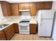 Kitchen featuring white appliances, laminate countertops and wooden cabinets at 2160 Highpointe Dr # 102, Laughlin, NV 89029