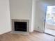Living room with a fireplace, wood floors and sliding door to the outside at 2160 Highpointe Dr # 102, Laughlin, NV 89029
