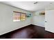 Bedroom featuring hardwood floors, a window for natural light, and shelving for additional storage at 2204 Short Pine Dr, Las Vegas, NV 89108