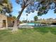 Inviting community pool area with lounge chairs, mature trees, and a serene setting for relaxation at 2204 Short Pine Dr, Las Vegas, NV 89108