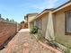 Exterior shot showcasing a desert-friendly backyard, stucco walls, and tiled walkway at 2204 Short Pine Dr, Las Vegas, NV 89108