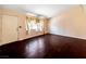 Spacious living room featuring hardwood floors, bright windows, and access to the front door at 2204 Short Pine Dr, Las Vegas, NV 89108