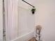 Clean white tiled bathroom and tub with shower at 2725 S Nellis Blvd # 1037, Las Vegas, NV 89121