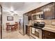 A kitchen with stainless steel appliances and dark cabinets offers a functional space for cooking at 2725 S Nellis Blvd # 1037, Las Vegas, NV 89121