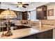 An efficient kitchen shows dark wood cabinets, granite countertops, and stainless steel appliances at 2725 S Nellis Blvd # 1037, Las Vegas, NV 89121