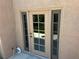 Back door of house with glass and security screen looks out onto green turf yard at 2728 Aspen Wood Ave, Henderson, NV 89074