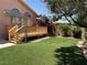 Serene backyard showcasing a wood deck, artificial turf, and mature landscaping for outdoor enjoyment at 2728 Aspen Wood Ave, Henderson, NV 89074