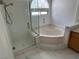 Bathroom with glass-enclosed shower, soaking tub, and tiled floors at 2728 Aspen Wood Ave, Henderson, NV 89074