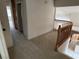 Upstairs hallway featuring carpet, wood railing, and access to multiple rooms at 2728 Aspen Wood Ave, Henderson, NV 89074