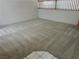 Large living area with neutral carpet and wood railing, creating an inviting space at 2728 Aspen Wood Ave, Henderson, NV 89074