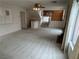 Spacious living room featuring carpet, ceiling fan, bar area, stairs and large windows at 2728 Aspen Wood Ave, Henderson, NV 89074