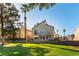 Inviting backyard with a patio, lawn, and mature trees at 2845 Queens Courtyard Dr, Las Vegas, NV 89109