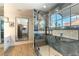 Bathroom featuring an open glass shower with a view of palm trees at 2845 Queens Courtyard Dr, Las Vegas, NV 89109