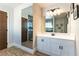 Bright bathroom vanity with a view of an open shower and bathroom doors at 2845 Queens Courtyard Dr, Las Vegas, NV 89109