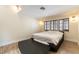 Comfortable bedroom featuring three windows, wood-look floors, and overhead lighting at 2845 Queens Courtyard Dr, Las Vegas, NV 89109