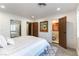 A bedroom featuring wood-look floors and multiple doors at 2845 Queens Courtyard Dr, Las Vegas, NV 89109