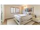 Bedroom features wood-look floors, windows with wooden blinds, and a piece of framed art at 2845 Queens Courtyard Dr, Las Vegas, NV 89109