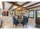 Elegant dining room with modern chandelier, seating for six, and built-in shelving at 2845 Queens Courtyard Dr, Las Vegas, NV 89109
