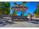 Elegant entrance to the Las Vegas Country Club Estates with lush landscaping and stone signage at 2845 Queens Courtyard Dr, Las Vegas, NV 89109