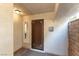 Inviting entryway with dark wood door, decorative tile, and neutral walls at 2845 Queens Courtyard Dr, Las Vegas, NV 89109