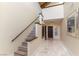 Bright foyer with stairway, tiled floor, and elegant artwork on display at 2845 Queens Courtyard Dr, Las Vegas, NV 89109
