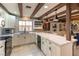 Well-lit kitchen featuring white cabinets, marble countertops, and updated appliances at 2845 Queens Courtyard Dr, Las Vegas, NV 89109