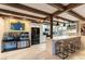 Modern kitchen with marble countertops, bar seating, and stainless steel refrigerator at 2845 Queens Courtyard Dr, Las Vegas, NV 89109
