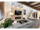 Comfortable living room with high ceilings, fireplace, and neutral-toned sectional sofa at 2845 Queens Courtyard Dr, Las Vegas, NV 89109