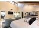 Spacious bedroom with vaulted ceiling, plush seating area, and lots of natural light at 2845 Queens Courtyard Dr, Las Vegas, NV 89109