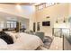 Spacious bedroom with vaulted ceiling, plush seating area, and lots of natural light at 2845 Queens Courtyard Dr, Las Vegas, NV 89109