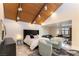 Spacious bedroom with vaulted ceiling, plush seating area, and lots of natural light at 2845 Queens Courtyard Dr, Las Vegas, NV 89109