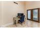 Bright office space with natural light, desk area, and double door access to the outdoors at 2845 Queens Courtyard Dr, Las Vegas, NV 89109