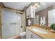 Bathroom featuring granite counters, tiled shower with sliding doors, updated lighting at 2995 E Sunset Rd # 134, Las Vegas, NV 89120