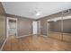 Neutral bedroom features hardwood flooring, closet with mirrored doors, and ceiling fan at 2995 E Sunset Rd # 134, Las Vegas, NV 89120