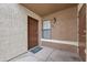 Home entrance with exterior wall and door, featuring neutral colors and tiled floor at 2995 E Sunset Rd # 134, Las Vegas, NV 89120